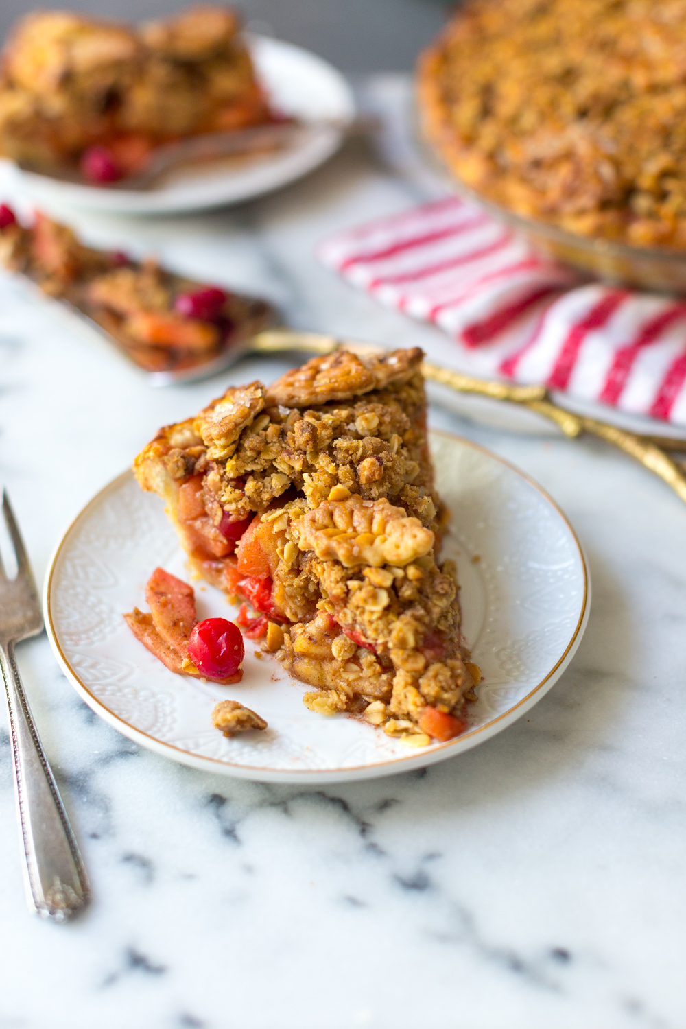 A thick slice of Cranberry Apple Brown Butter Crumble Pie.