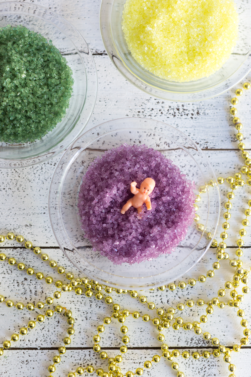 Crepe King Cake - sprinkles, baby JC & mardi gras beads