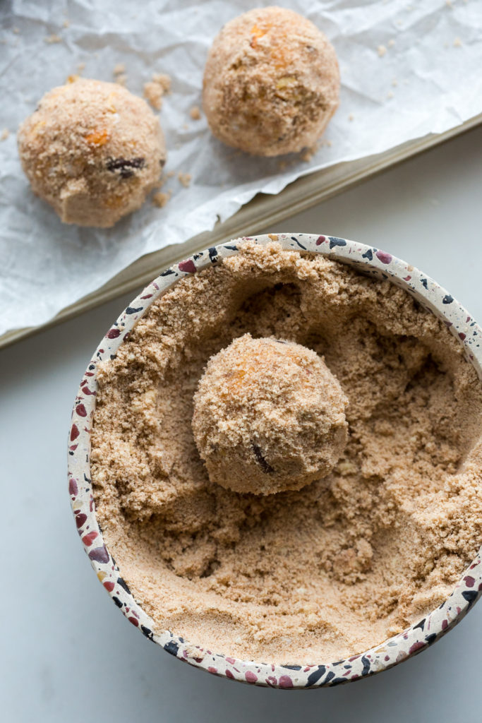 Coating Basic Energy Balls in almond flour and cinnamon mixture