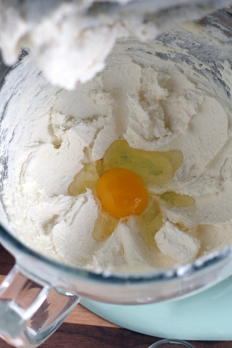 an egg sits in the whipped butter and sugar