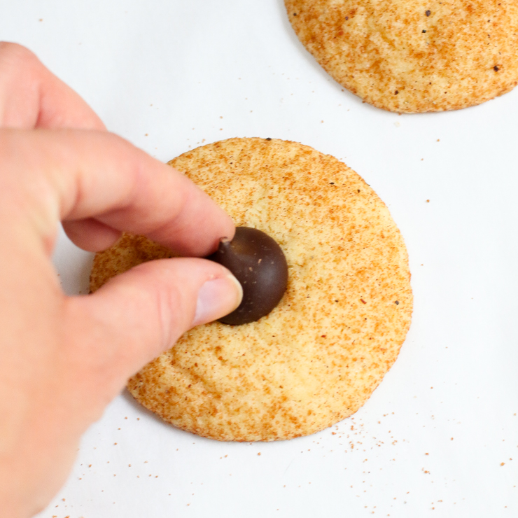 Adding a kiss to Snickerdoodle Kiss Cookies