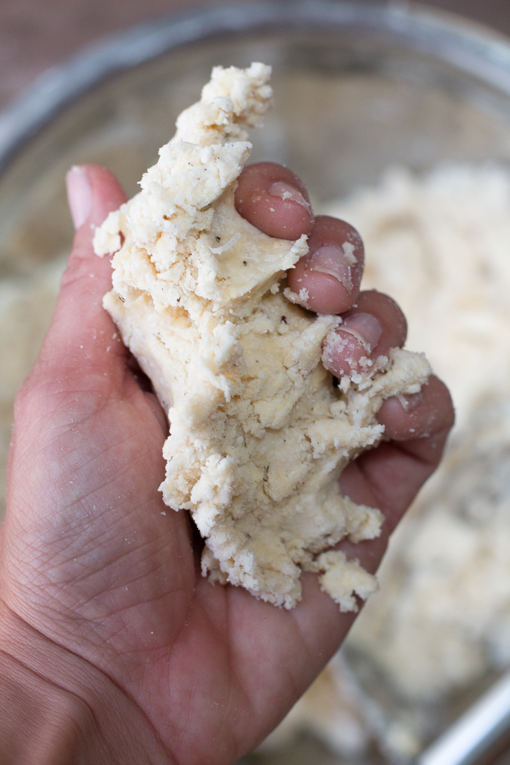 Squeezing the pepper crust dough to test how it holds together