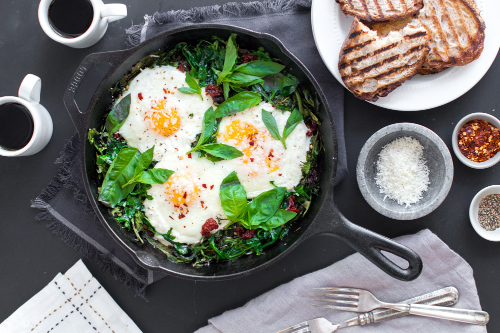 Baked Eggs with Ricotta, Greens & Sun Dried Tomatoes Baking the Goods