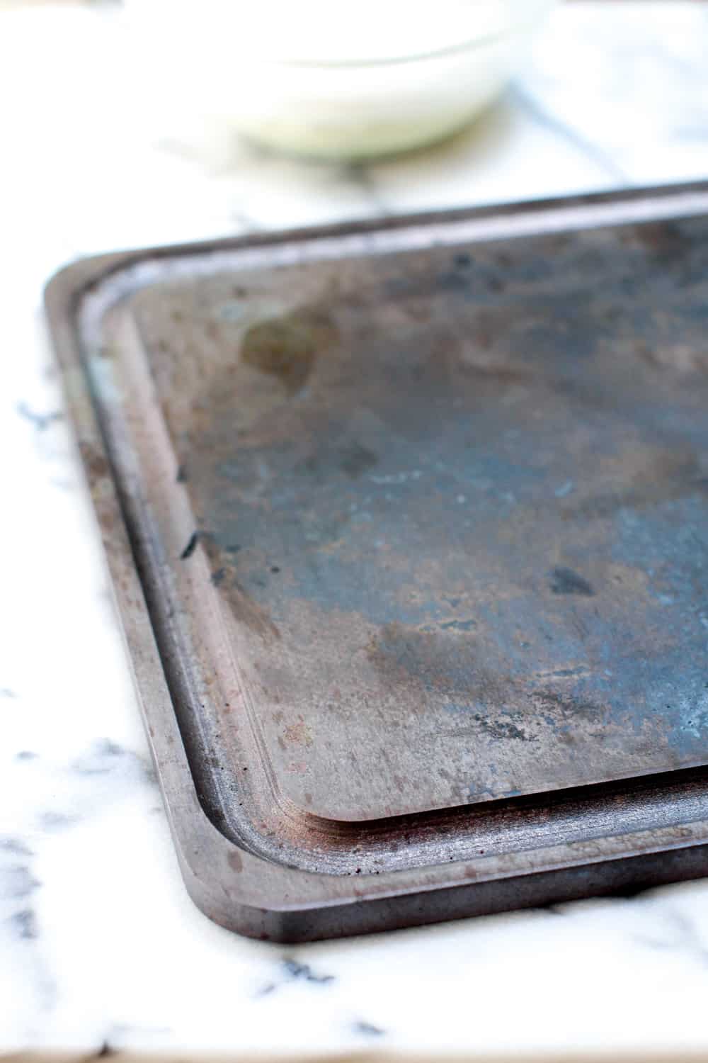 a slab of well-used Baking Steel for perfect pizza