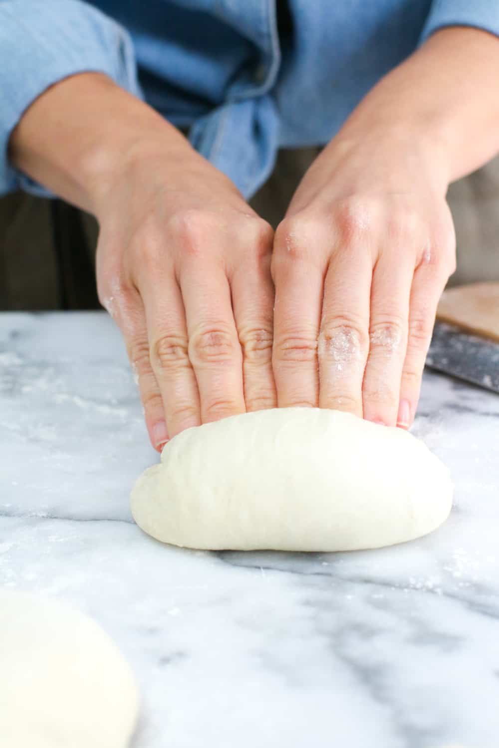 Folding the dough like an envelope. bottom up, then top down.