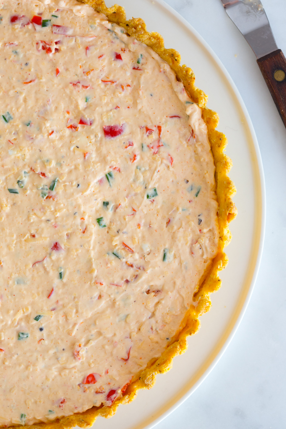 Filling the Heirloom Tomato and Pimento Cheese Tart with Cornmeal Crust