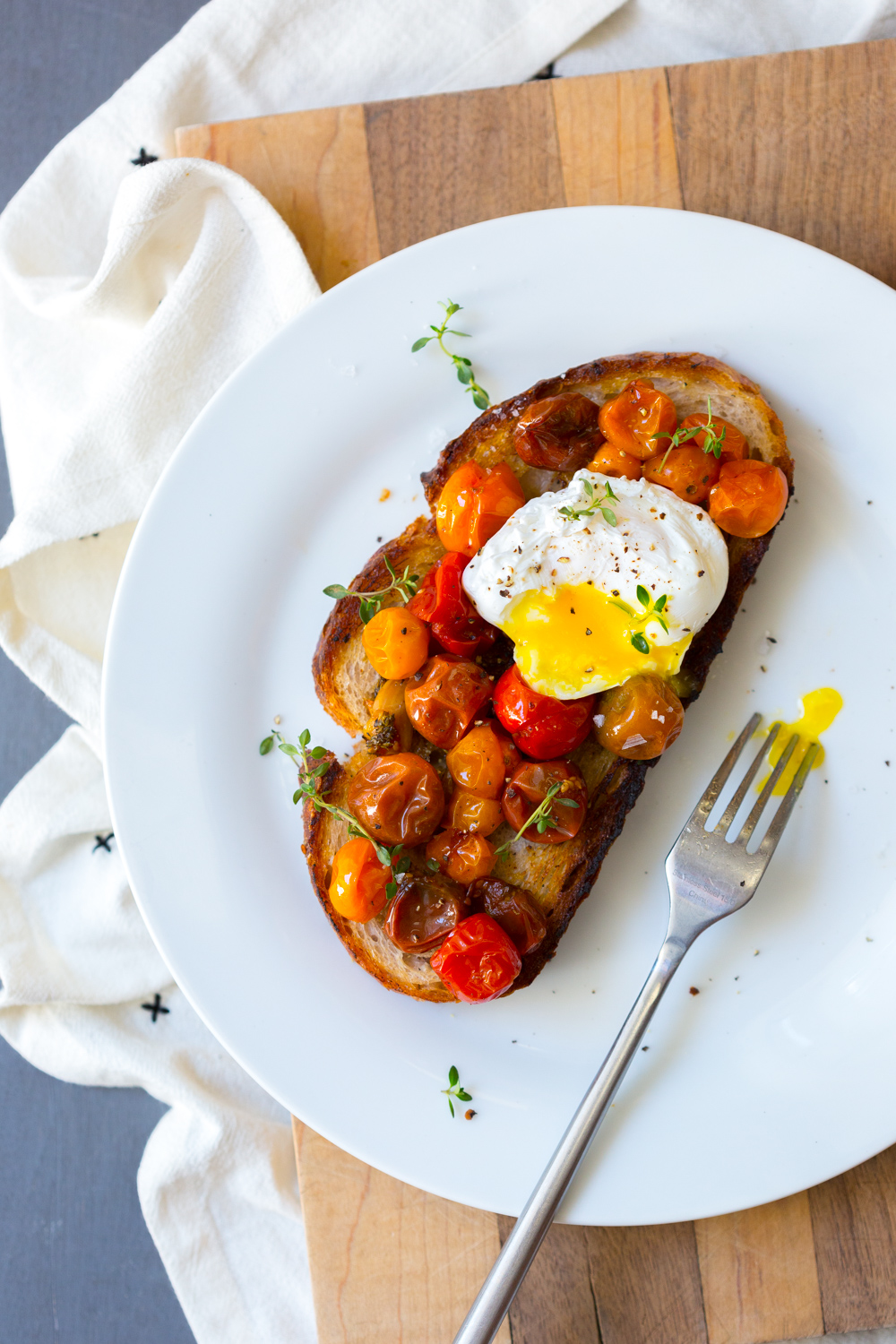 Cherry Tomato Confit with a poached egg on toast