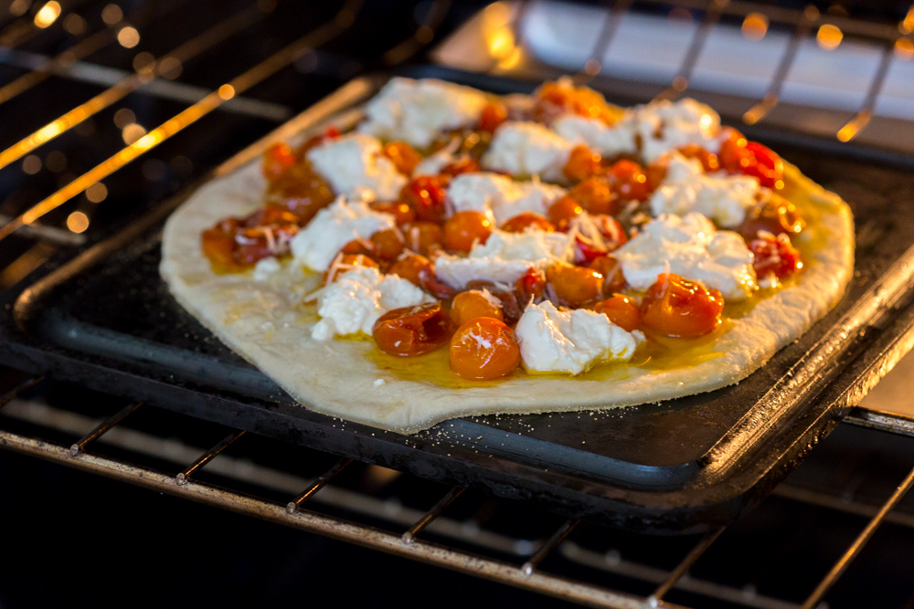 Tomato Confit Burrata and Arugula Pizza baking on Baking Steel