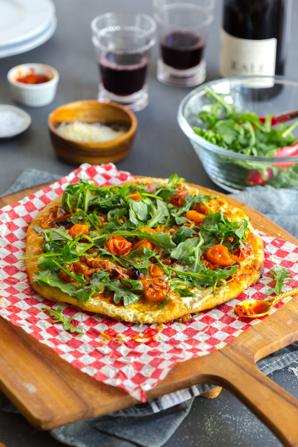 This Tomato Confit Burrata and Arugula Pizza is best served with a bottle of red, I love it with my red blend by Kale Wines.
