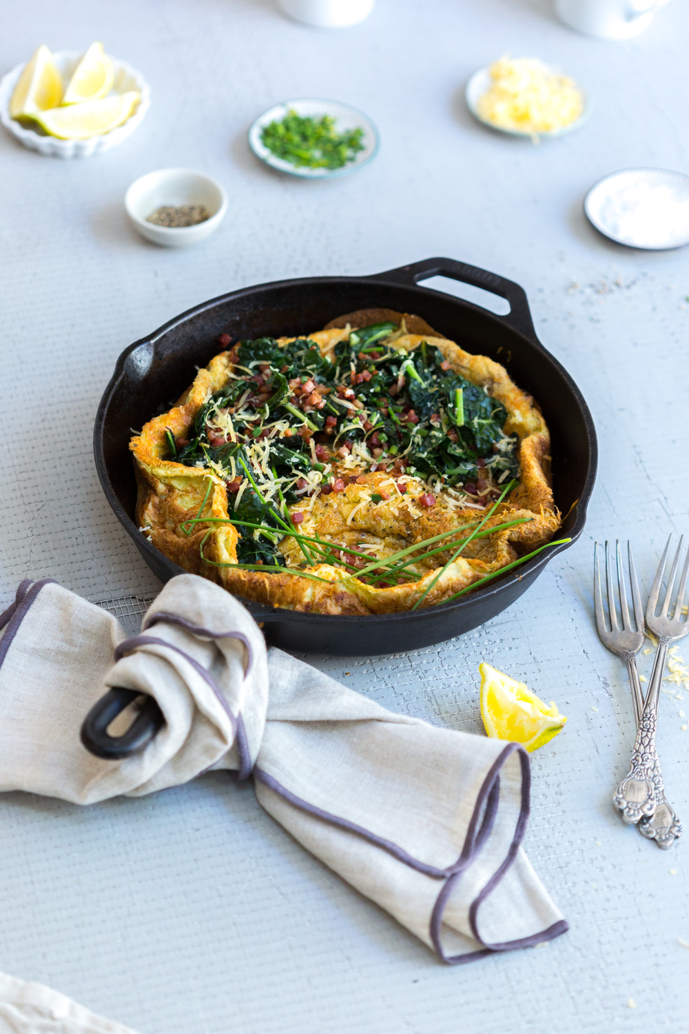 Aged Gouda Pancetta and Kale Savory Dutch Baby baked in a cast iron skillet