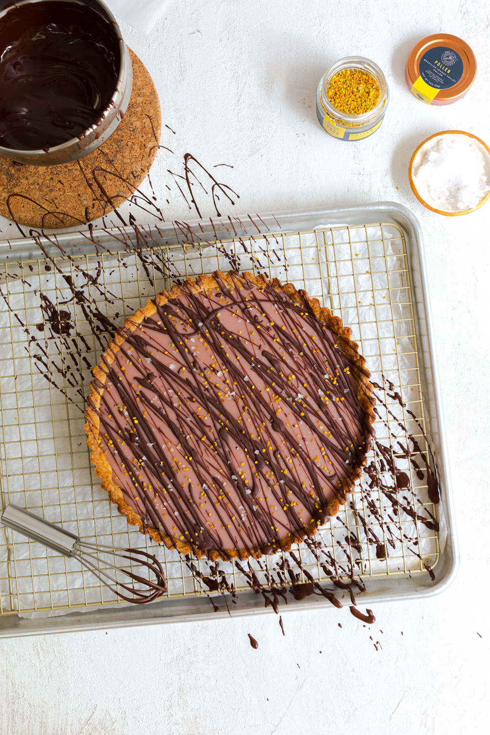 Adding see salt flakes and bee polled to the Ruby Cacao Ganache Tart