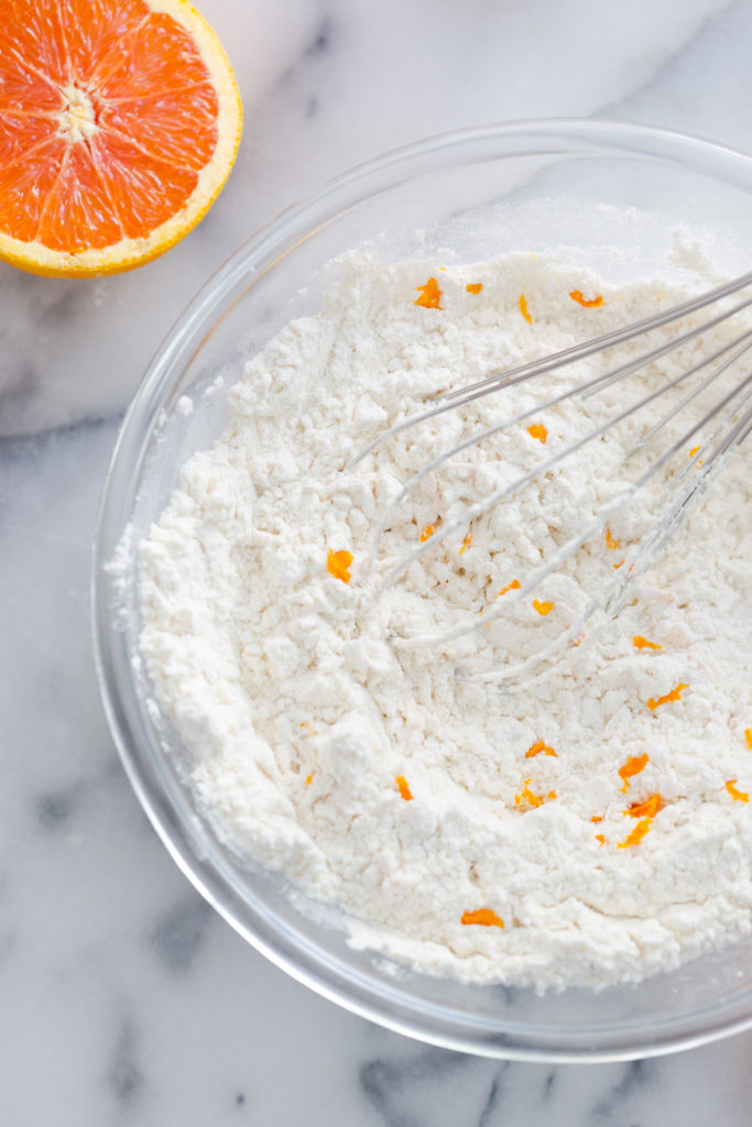 Adding orange zest to dry cookie ingredients