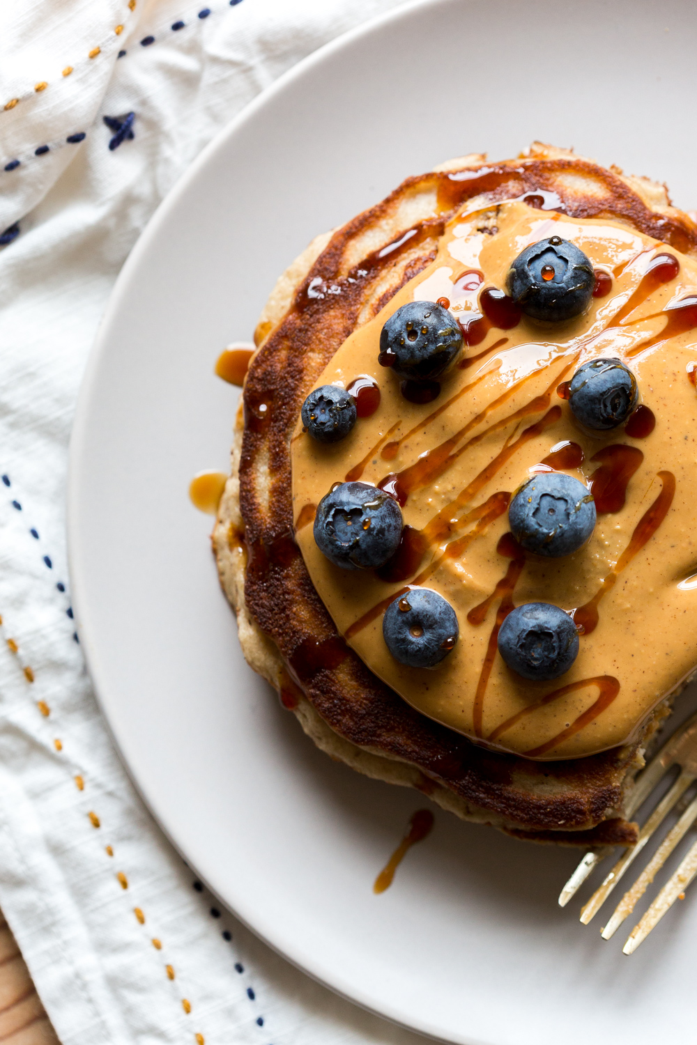 Gluten Free Almond Flour Banana Pancakes with almond butter, blueberries and syrup