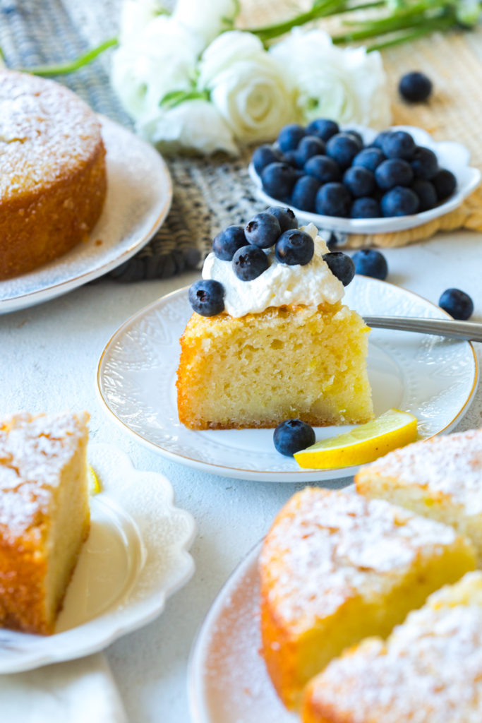 Slice of Limoncello Olive Oil Cakes with whipped cream and blueberries