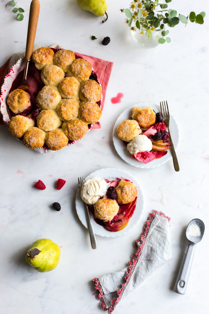 Serving Baby biscuits atop Pear Berry Cobbler with vanilla ice cream