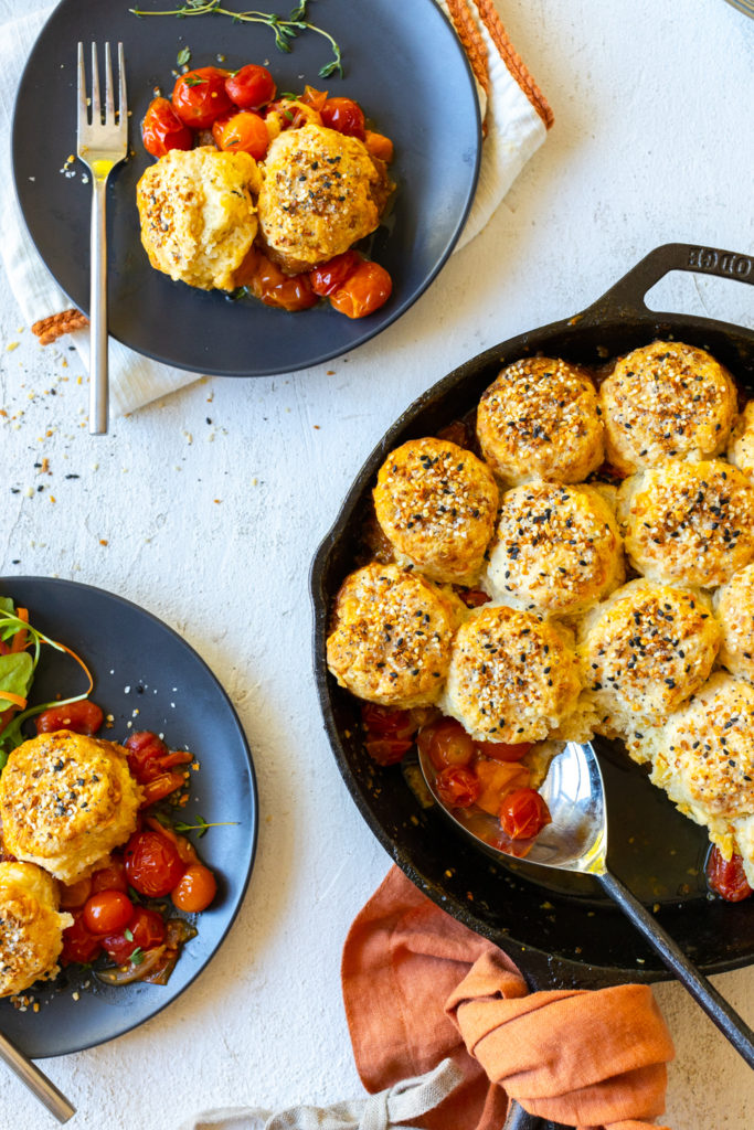 Scooping Cherry Tomato Cobbler with Cheddar Everything Biscuits