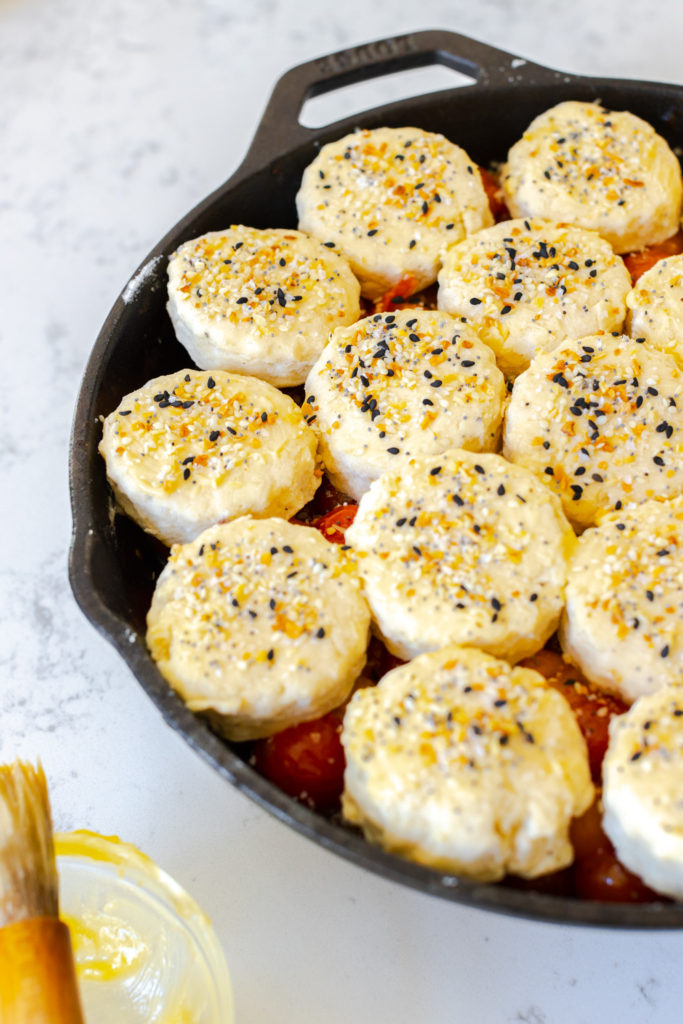 Assembling the Cherry Tomato Cobbler with Cheddar Everything Biscuits