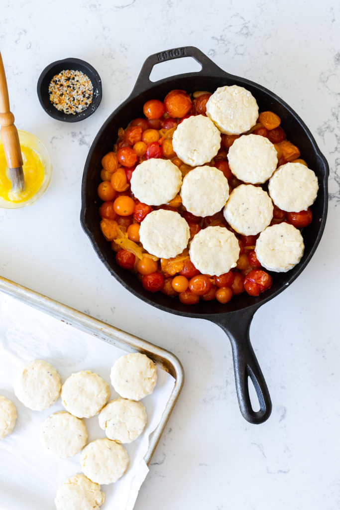Assembling the Cherry Tomato Cobbler with Cheddar Everything Biscuits