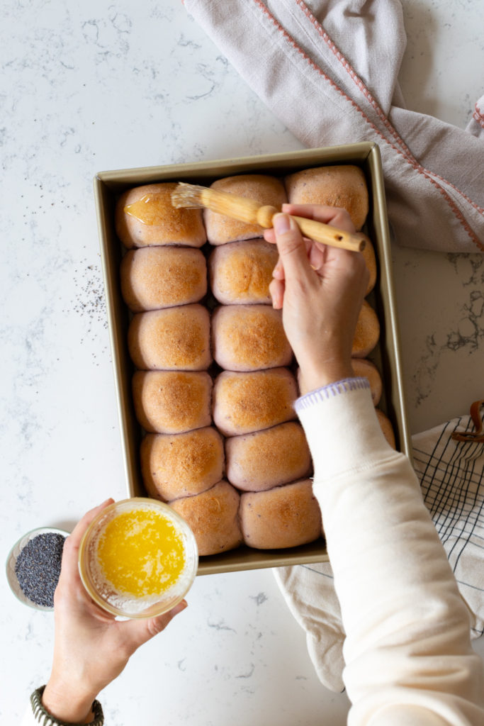 buttering warm baked rolls