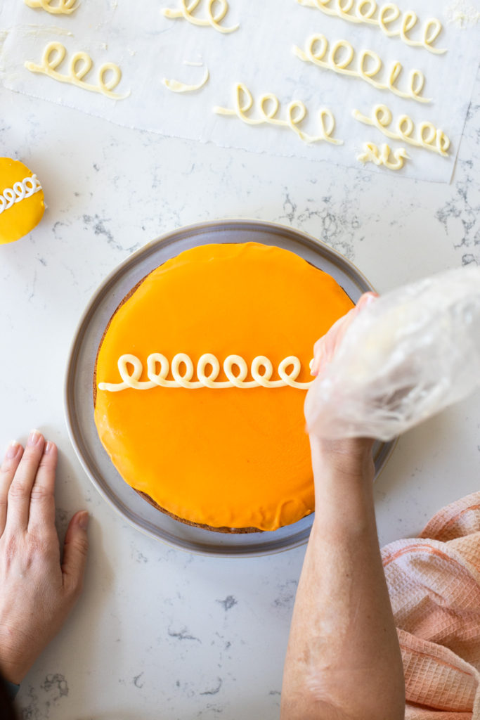 piping on the Orange Cream Cake swirl
