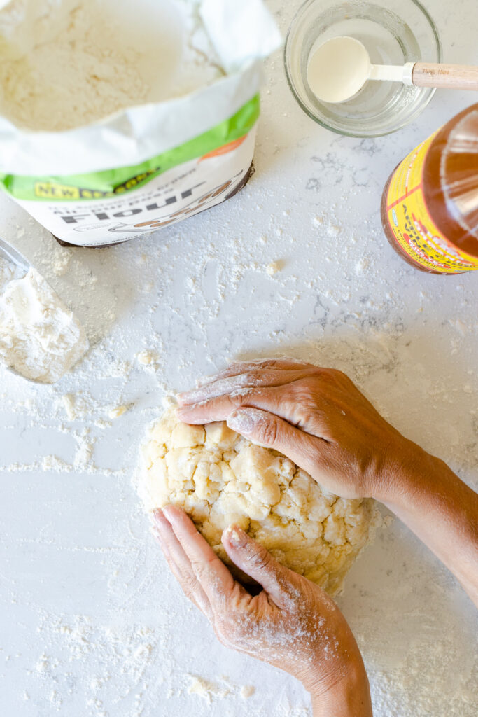 gathering the Basic All Butter Pie Dough into a disk