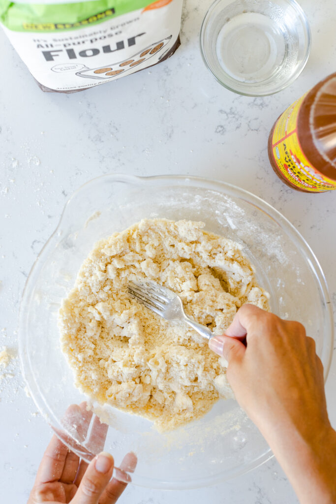 blending pie dough with fork