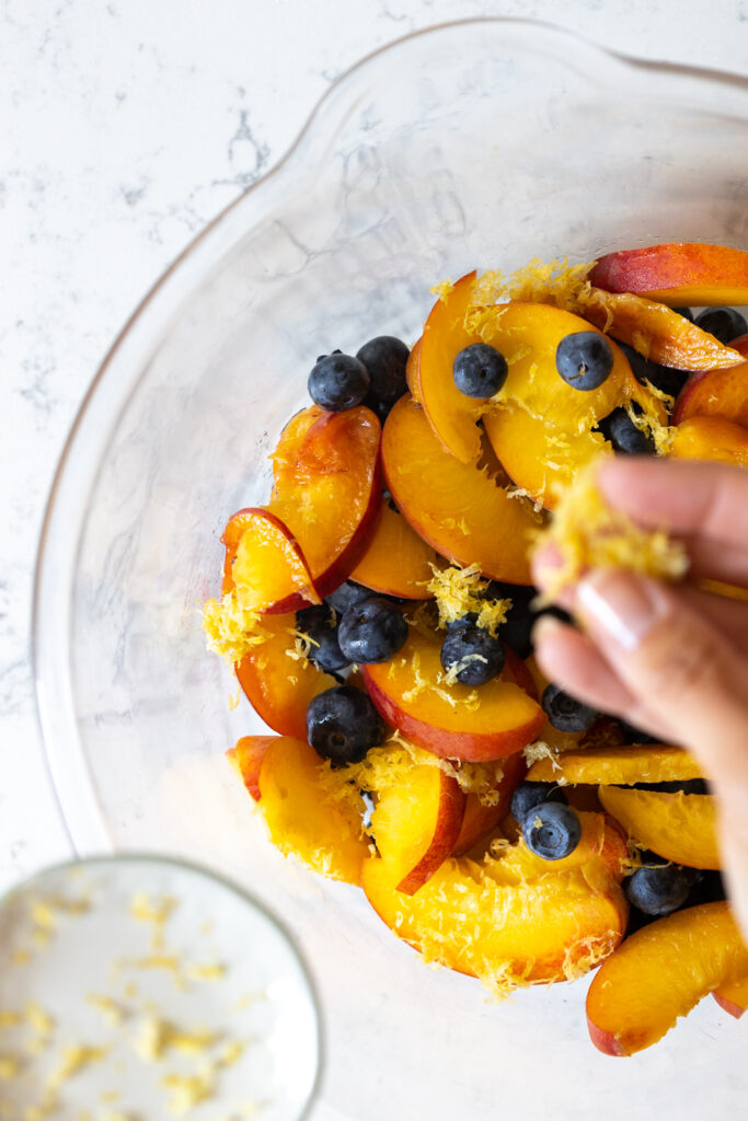 Adding lemon zest to blueberry peach filling