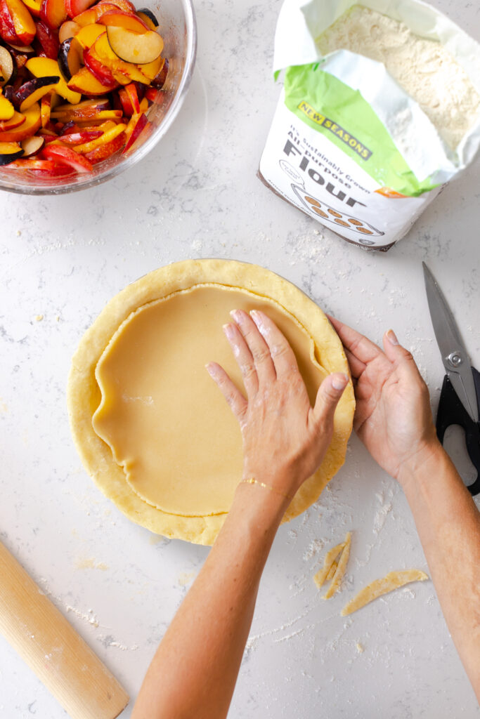 adding almond paste layer to bottom pie dough