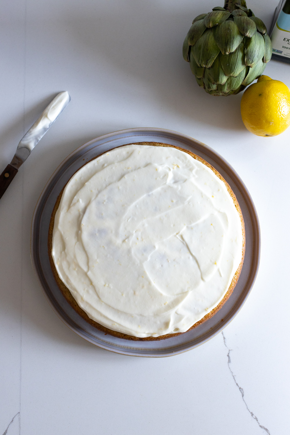 Frosting the Artichoke Olive Oil Cake with Lemon Cream Cheese Frosting