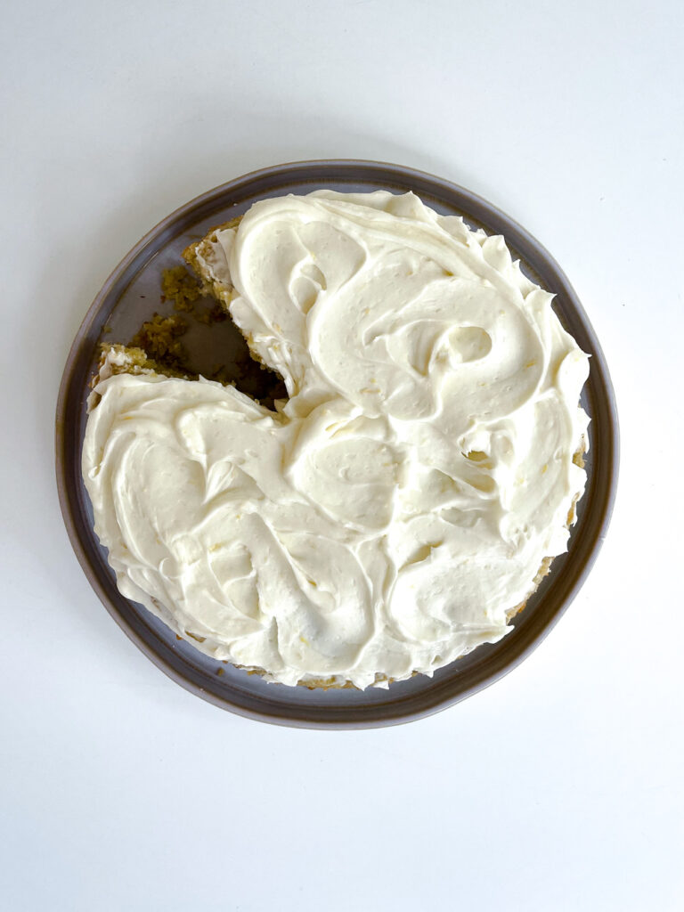 Swoopy swirls of Lemon Cream Cheese Frosting on Artichoke Olive Oil Cake.
