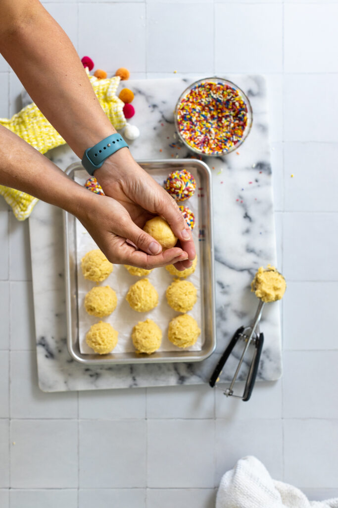 rolling lemon cookie dough into ball