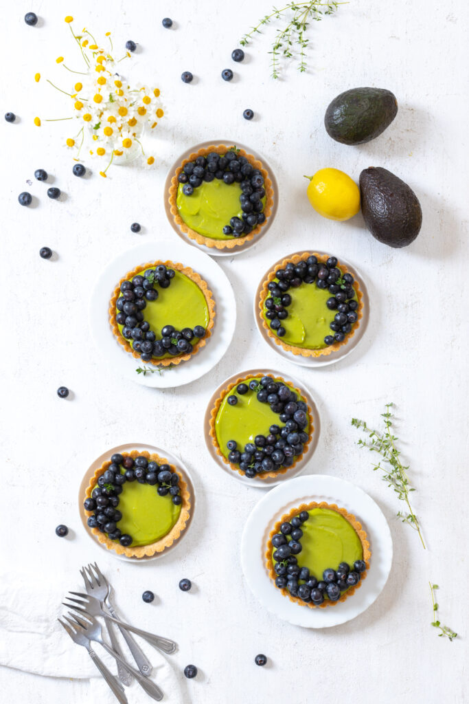Serving Avocado Blueberry Tarts with Almond Crust