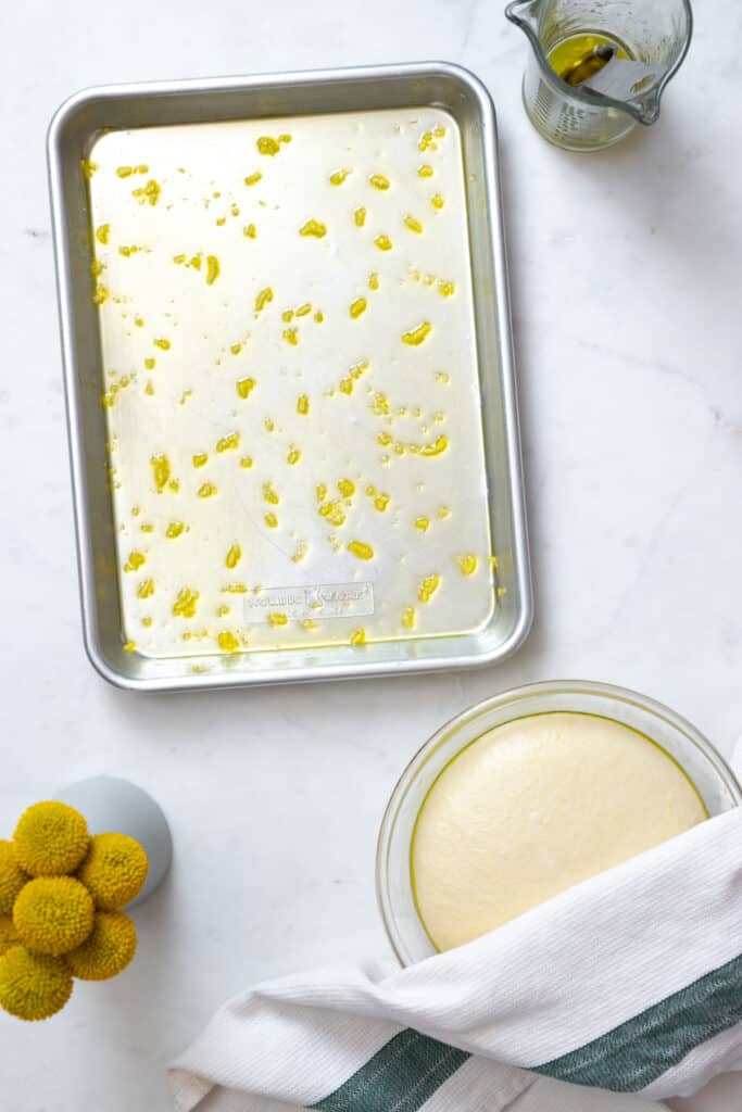 a baking pan with olive oil and garlic