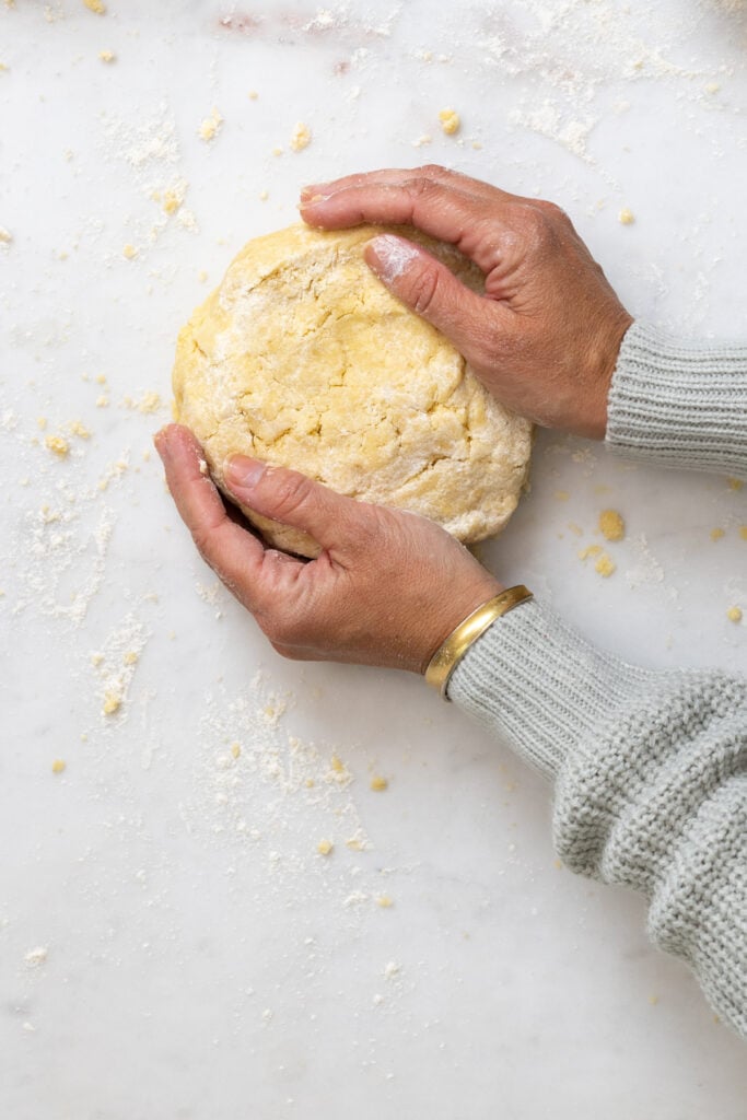 patting pie dough into disk