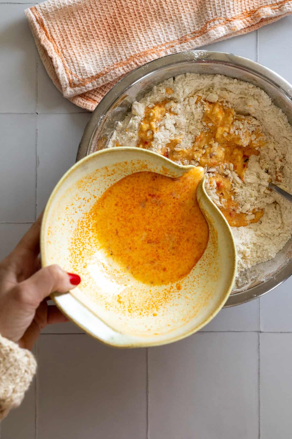 pouring wet ingredients into dry