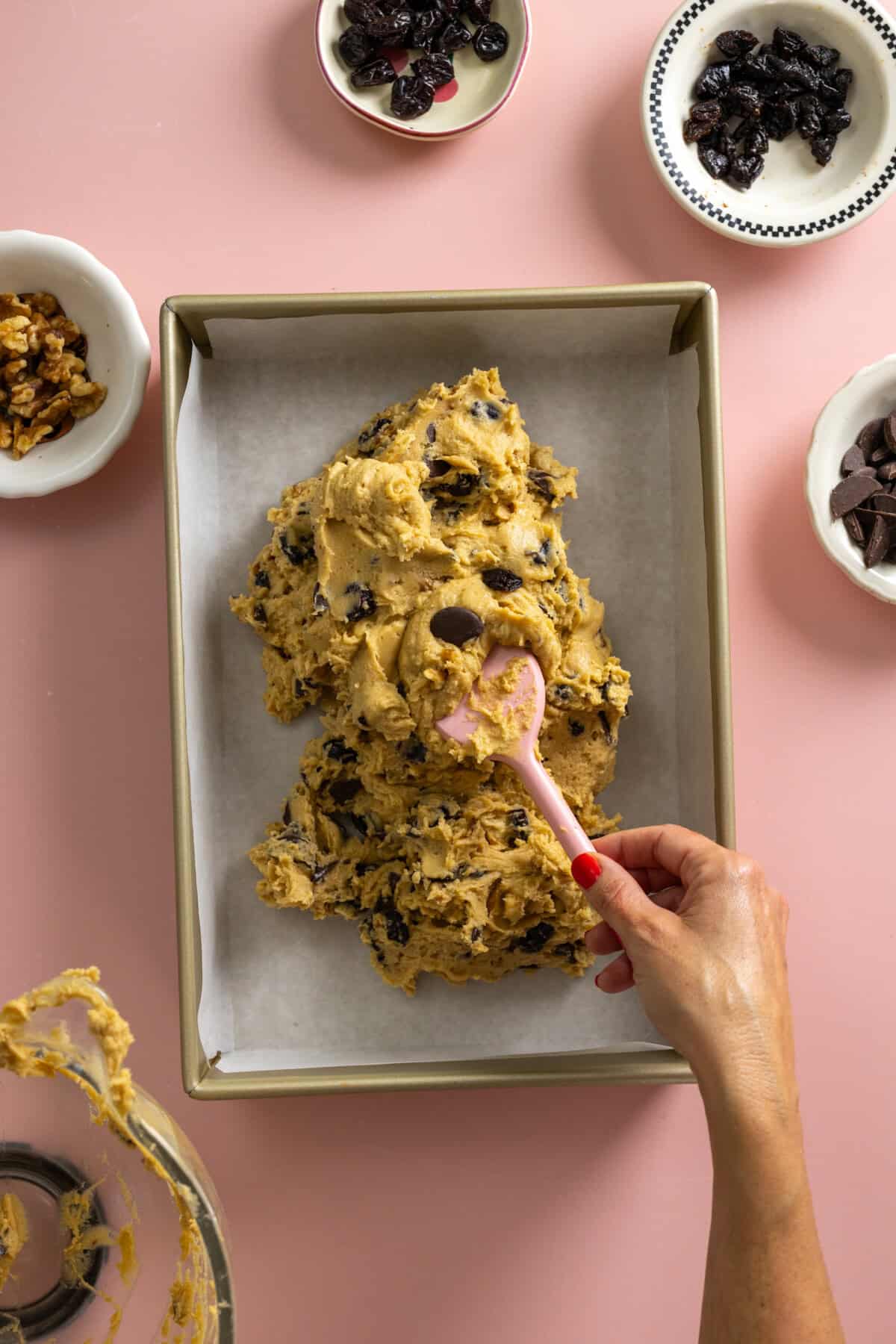 Pressing tahini bar dough into pan