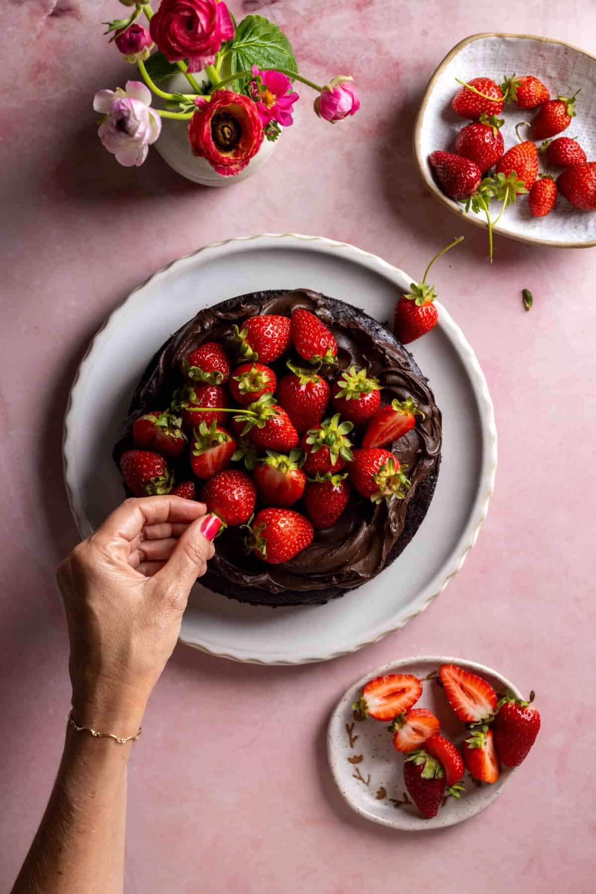 Topping the Avocado Chocolate Cake with Strawberries