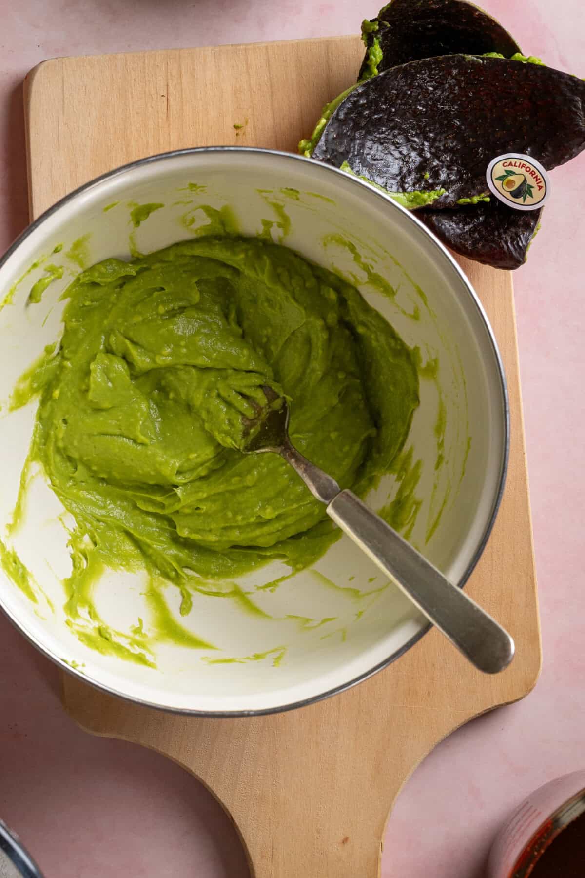smashing avocado with a fork