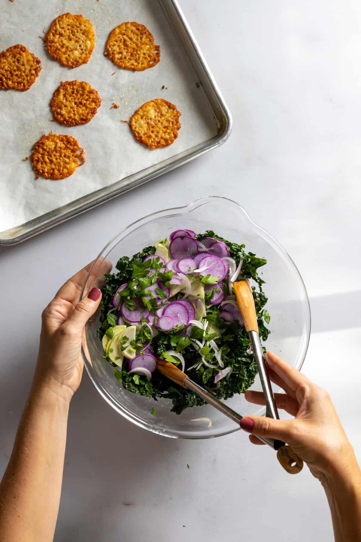 Tossing Kale Radish Kohlrabi Salad with dressing