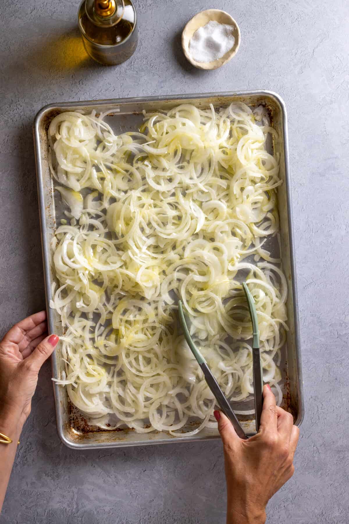 tossing onions with olive oil and salt