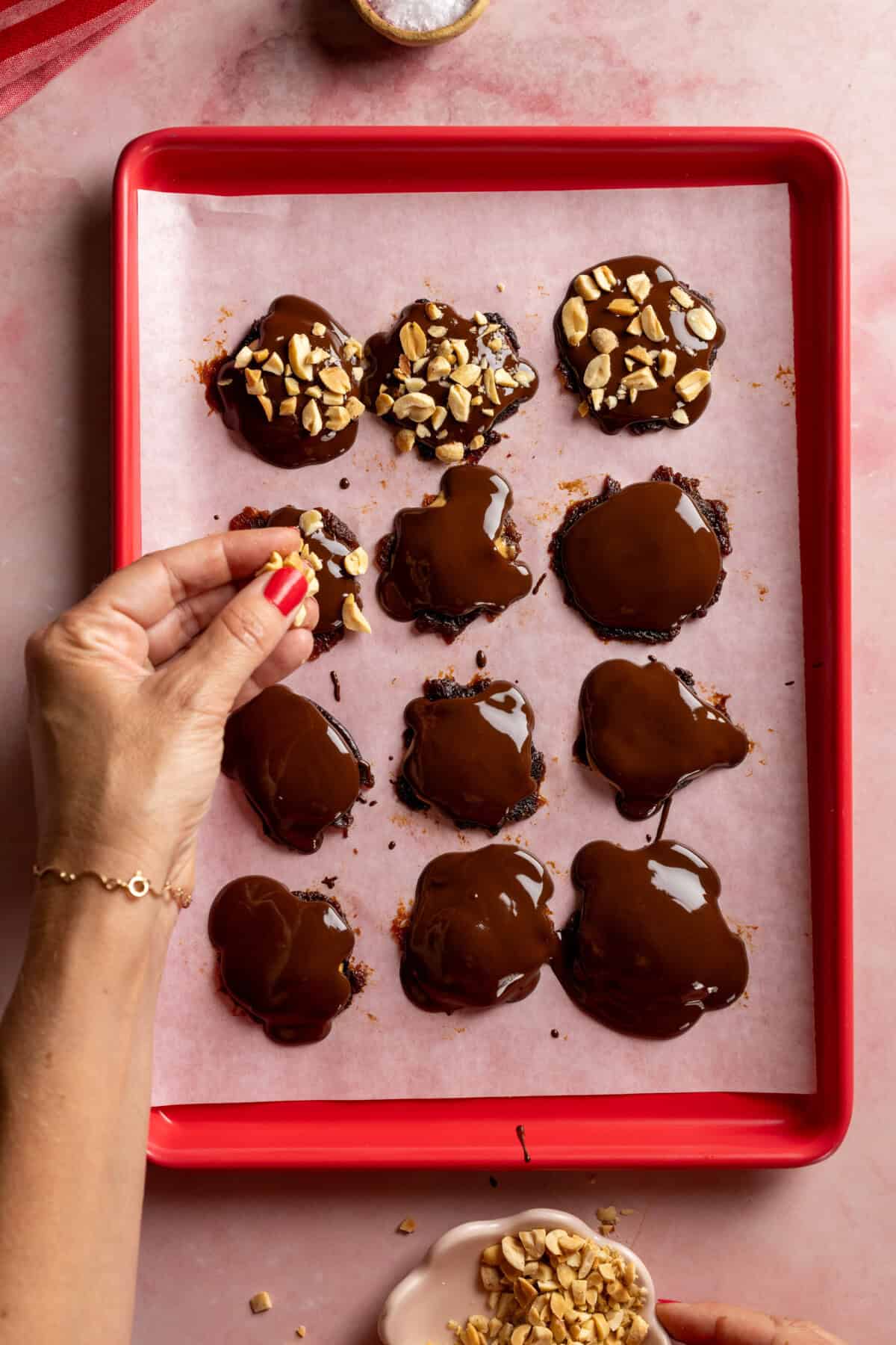 adding peanuts to Smashed Prune Snickers Bites